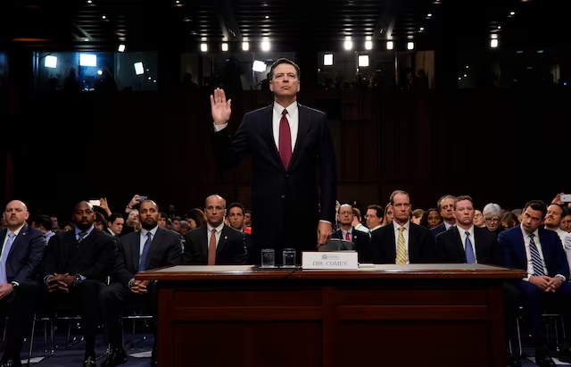 Former FBI Director James Comey is sworn in prior to testifying before a Senate Intelligence Committee hearing on Russia's alleged interference in the 2016 U.S. presidential election on Capitol Hill in Washington, U.S., June 8, 2017. REUTERS/Jonathan Ernst/ File Photo
