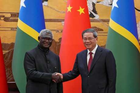 Visiting Solomon Islands Prime Minister Manasseh Sogavare, left, shakes hands with his Chinese counterpart Li Qiang after they witnessed signing an agreement for both countries at the Great Hall of the People in Beijing, July 10, 2023. (AP) Visiting Solomon Islands Prime Minister Manasseh Sogavare, left, shakes hands with his Chinese counterpart Li Qiang after they witnessed signing an agreement for both countries at the Great Hall of the People in Beijing, July 10, 2023. (AP)