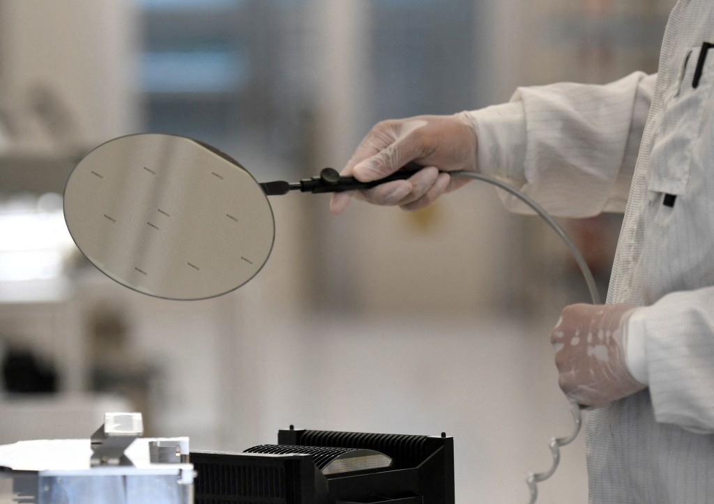 n employee works with a wafer in a production line of Dutch semiconductor company Nexperia, in Hamburg, Germany, June 27, 2024. (Reuters)
