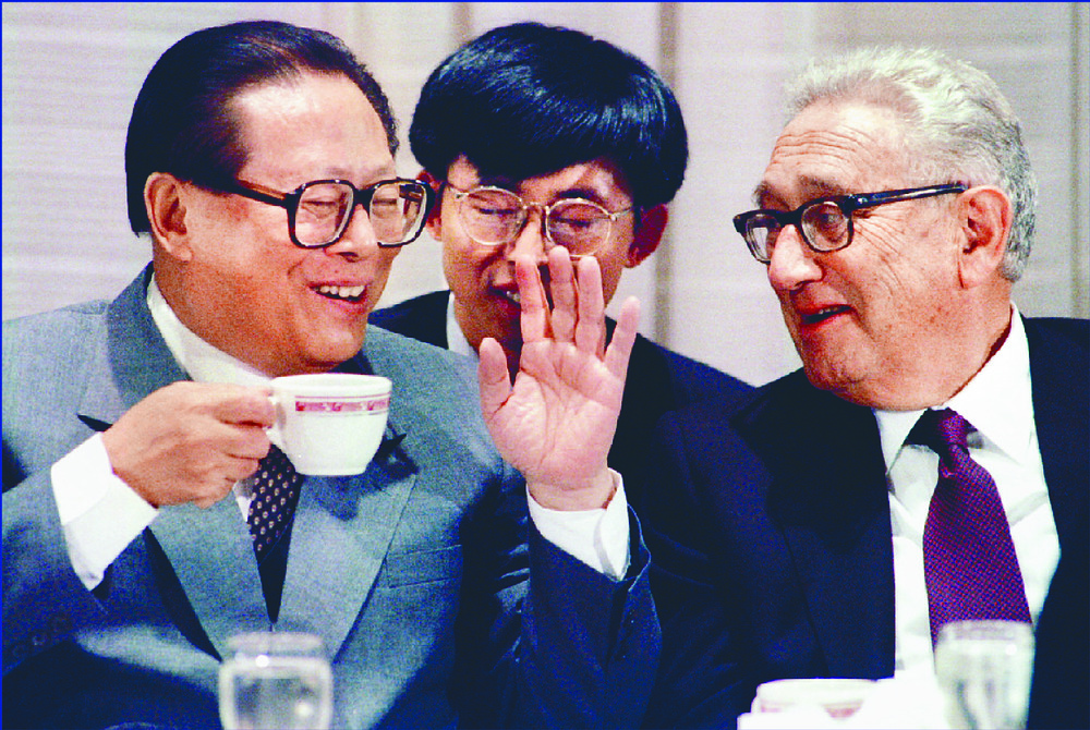 Clockwise from top left: Henry Kissinger meets with president Jiang Zemin in 1995, talks with USSR leader Leonid Brezhnev in 1973, arrives to a warm welcome from Nelson Mandela in 1994 and tries to ignore protesters at a Senate hearing. REUTERS, AFP