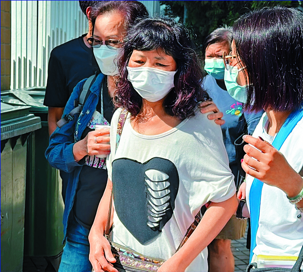 The deaths of two underground pipe workes are heartbreaking, says John Lee, as loved ones of the victims, including Kwok Fo-kee's wife, leave the mortuary and authorities inspect the site. SING TAO The deaths of two underground pipe workes are heartbreaking, says John Lee, as loved ones of the victims, including Kwok Fo-kee's wife, leave the mortuary and authorities inspect the site. SING TAO
