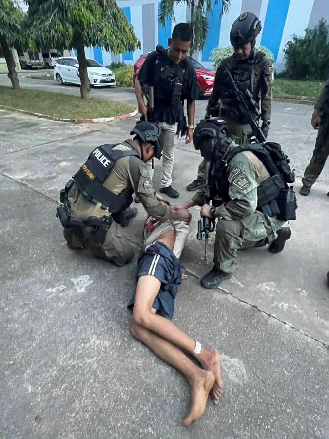 Police officers detain the gunman. Reuters