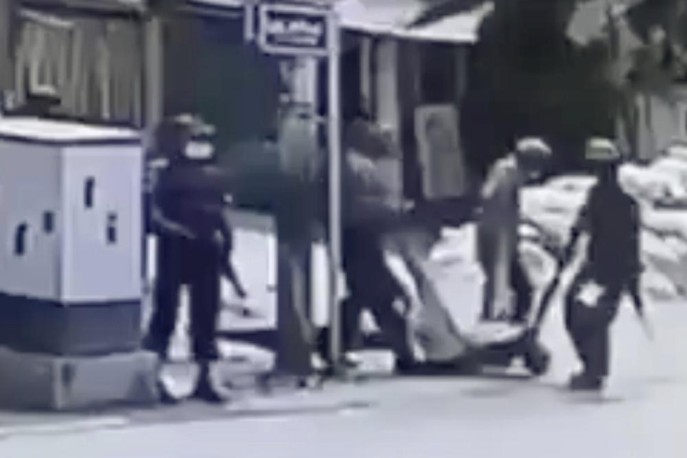 In this March 13, 2021 image from video obtained by The Associated Press, security forces carry the body of an unidentified individual in the Sein Pann ward of Mandalay, Myanmar. Access to technology and social media have allowed members of the public to create a body of real-time evidence that contradicts the state narrative and could eventually be used to help build an international criminal case while also making it difficult for foreign donors and developed nations to turn a blind eye to mounting atrocities. 