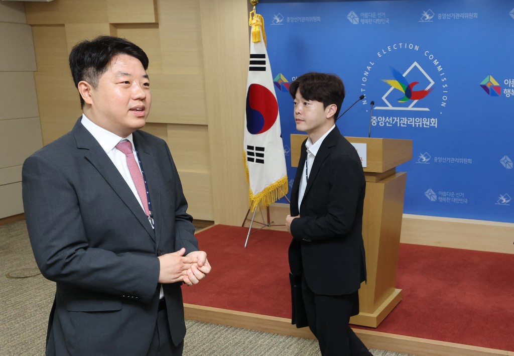 South Korean investigators on a prosecution-police task force enter the National Election Commission headquarters in Gwacheon on July 23, 2026, as they raid the election commission over indications officials falsified vote turnout figures in June local elections. (Photo by YONHAP / AFP)