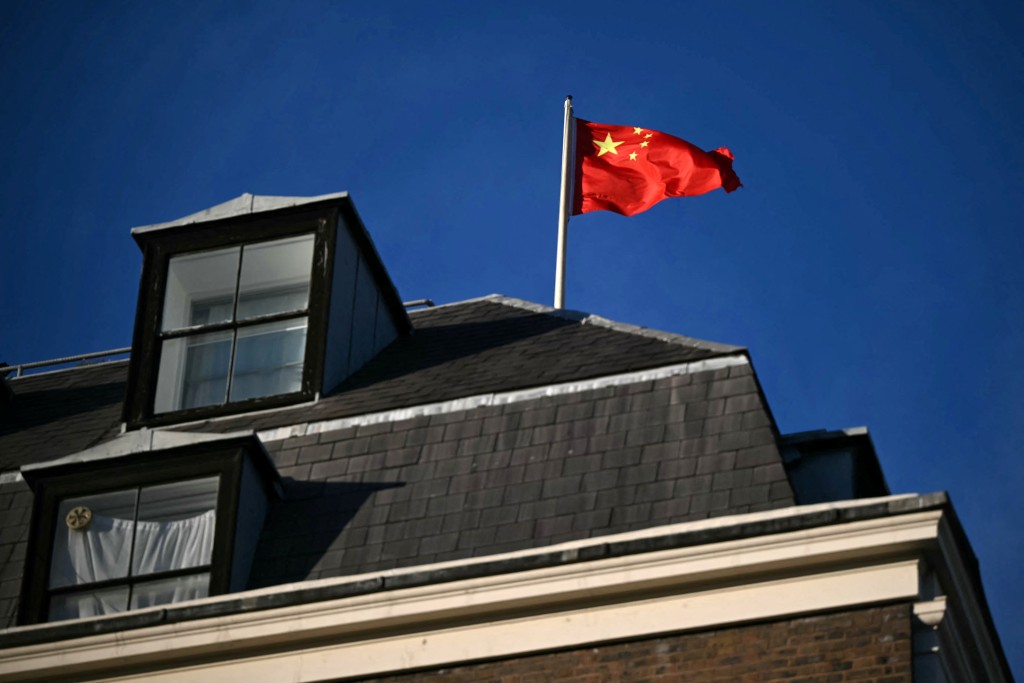 Photo by JUSTIN TALLIS / AFP  A flag flies atop a pole on the roof of the Embassy of the People's Republic of China in the United Kingdom, on Portland Place in London on November 18, 2025.
