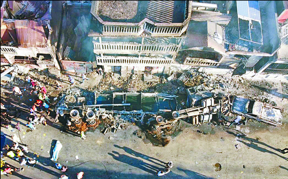 Onlookers gather around the remains of a gas tanker truck after it exploded in Cap-Hatiene, killing at least 75 people and destroying houses and buildings. AFP Onlookers gather around the remains of a gas tanker truck after it exploded in Cap-Hatiene, killing at least 75 people and destroying houses and buildings. AFP