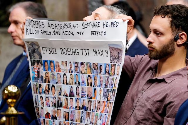 People hold a banner with pictures of victims of crashed Ethiopian Airlines flight 302 Boeing 737 MAX 8 during Senate Commerce, Science, and Transportation Committee hearing about Boeing’s commitment to address safety concerns in the wake of a January 2024 mid-air emergency involving a new 737 MAX, on Capitol Hill in Washington, D.C., U.S., April 2, 2025. REUTERS/Ken Cedeno/File Photo 