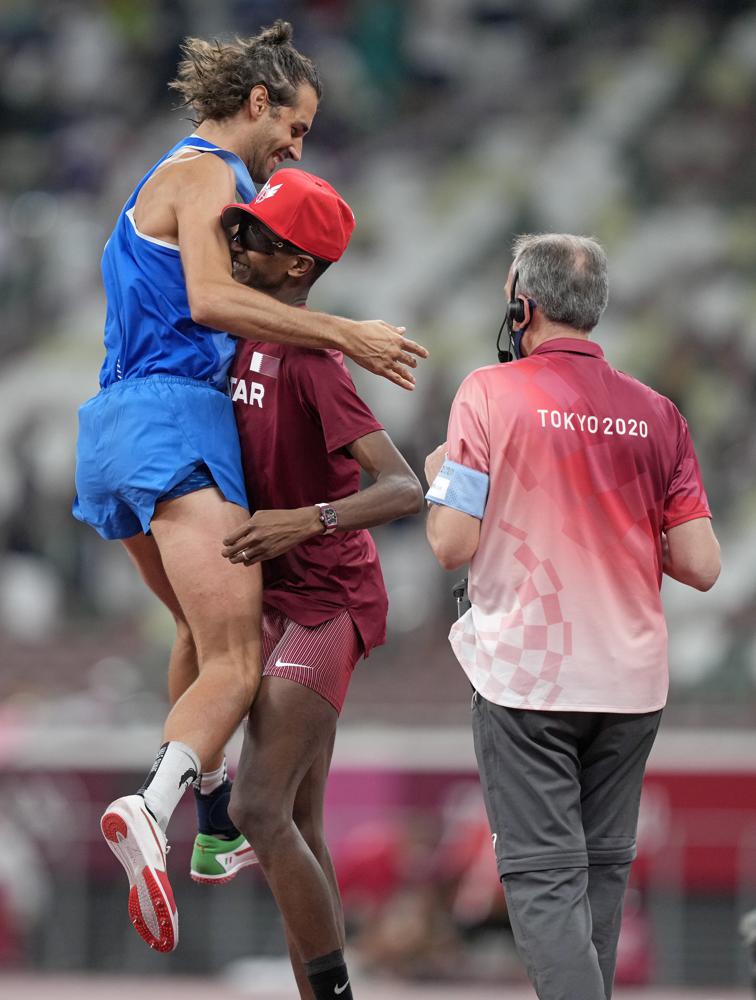 Gianmarco Tamberi, of Italy celebrates with Mutaz Barshim of Qatar after they won joint gold in the final of the men's high jump at the 2020 Summer Olympics, Sunday, Aug. 1, 2021, in Tokyo, Japan. 