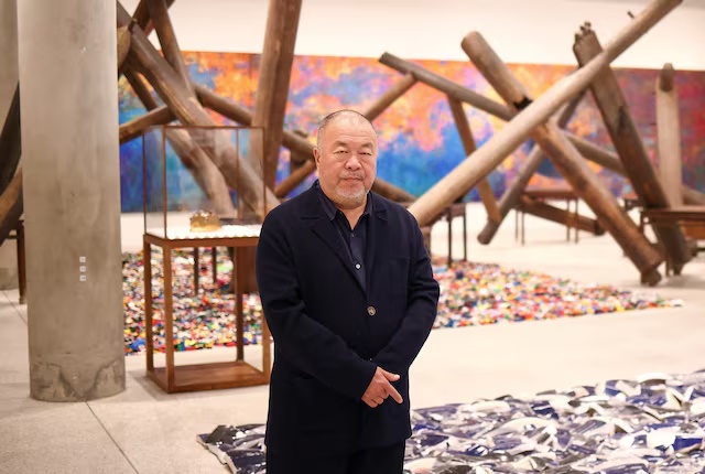 Chinese artist Ai Weiwei poses during a photocall, amongst art pieces displayed in his exhibition "Ai Weiwei: making sense" at the Design Museum in London, Britain, April 4, 2023. REUTERS/Henry Nicholls/File Photo 