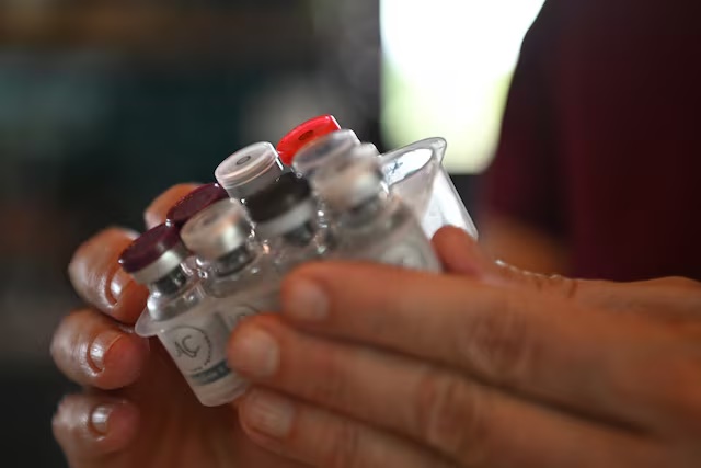 Amy Spencer holds a number of vials containing components of obesity drugs, which were purchased through the grey market, a new market that allows consumers to purchase obesity medication materials from China and reconstitute them into injectable drugs, at her home in southern Missouri, U.S. April 24, 2025. REUTERS/Callaghan O'Hare