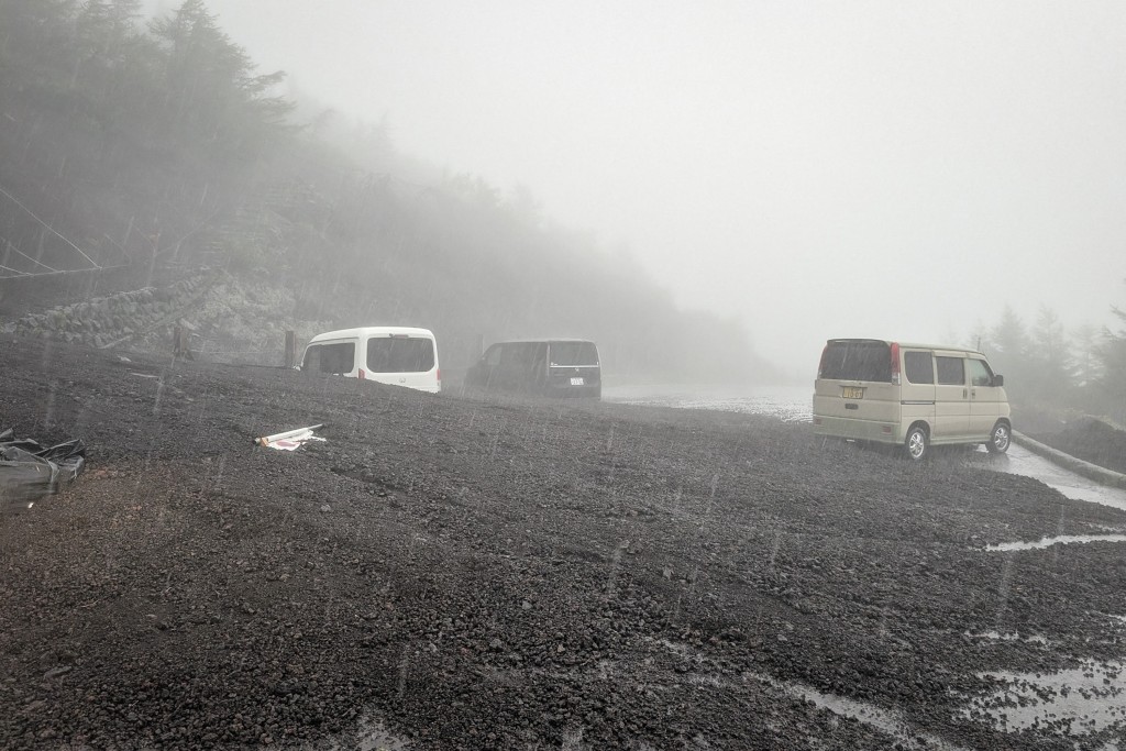 Photo by - / SHIZUOKA PREFECTURE / AFP  This handout photo taken on September 9, 2026 and received from Shizuoka prefecture on September 10, 2026 shows vehicles buried by mud and debris after a landslide swept into the parking lot at Fifth Station of Mount Fuji's Fujinomiya Trail in Fujinomiya, Shizuoka Prefecture.