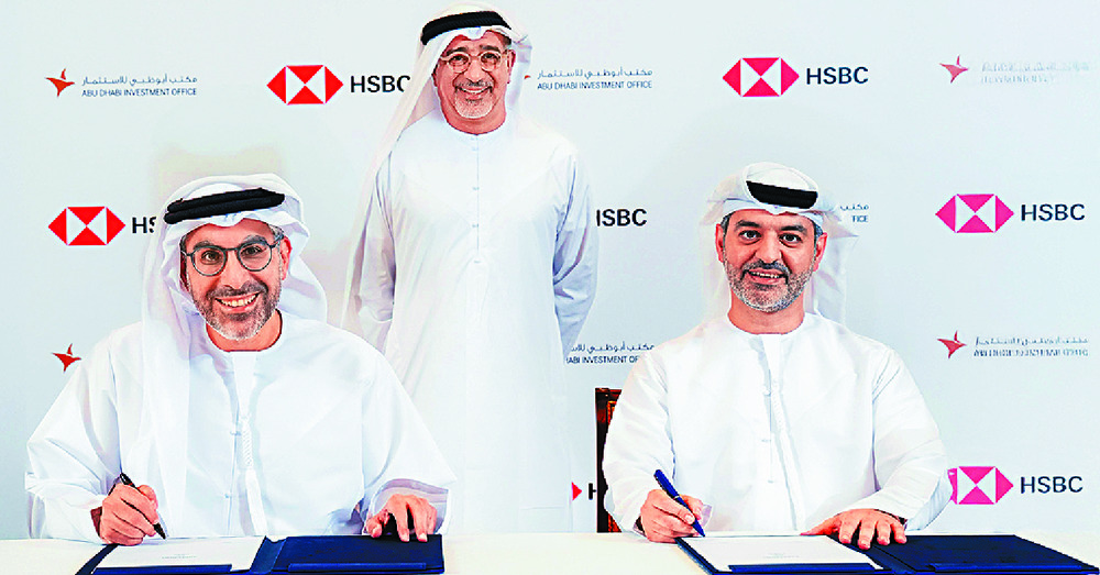 HSBC UAE chief executive Mohamed Al Marzooqi, right, and ADIO director general Badr Al-Olama sign the MoU in the presence of HSBC Bank Middle East chairman Abdulfattah Sharaf. HSBC UAE chief executive Mohamed Al Marzooqi, right, and ADIO director general Badr Al-Olama sign the MoU in the presence of HSBC Bank Middle East chairman Abdulfattah Sharaf.