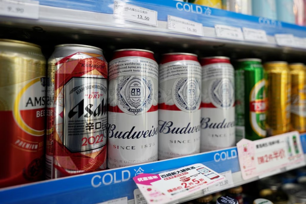 Cans of Budweiser beer are displayed amid others on a supermarket shelf in Shanghai, China. REUTERS