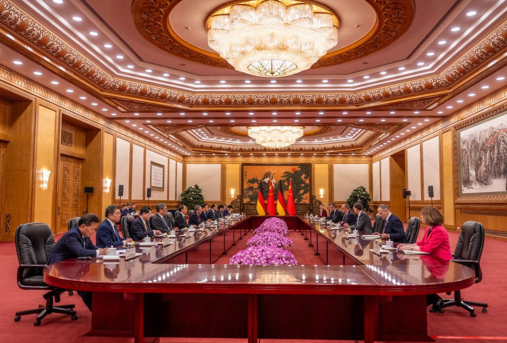 Photo by MICHAEL KAPPELER / POOL / AFP German Chancellor Friedrich Merz (4th R) attends a meeting with China’s Premier Li Qiang (5th L) at the Great Hall of the People in Beijing on February 25, 2026.