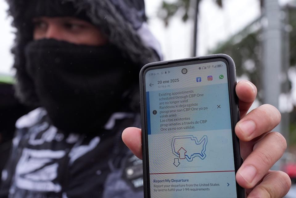 FILE - A migrant seeking asylum holds up the CBP One app showing his appointment was canceled after President Donald Trump was sworn into office, Jan. 20, 2025, in Matamoros, Mexico. (AP Photo/Eric Gay, File)