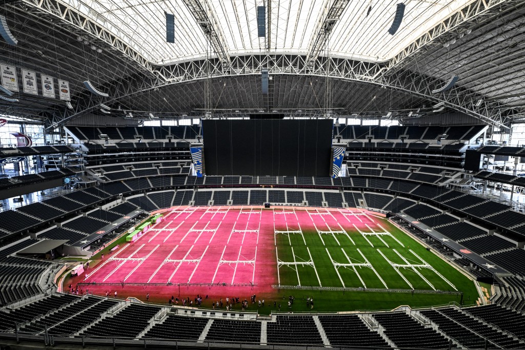 Dallas Stadium (temporarily renamed from AT&T Stadium for the 2026 FIFA World Cup) is seen with purple lights illuminating the field to promote grass growth, in Arlington, Texas, on May 14, 2026. (Photo by RONALDO SCHEMIDT / AFP)