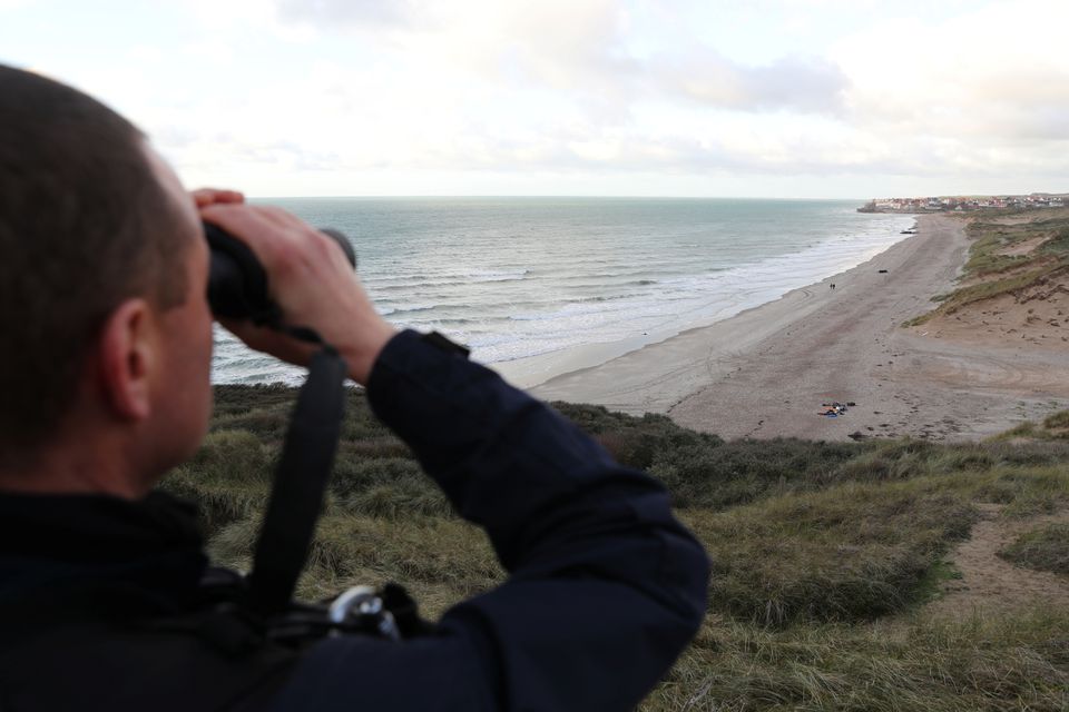 French police patrol the Slack dunes, the day after 27 migrants died when their dinghy deflated as they attempted to cross the English Channel, in Wimereux, near Calais, France. (Reuters) French police patrol the Slack dunes, the day after 27 migrants died when their dinghy deflated as they attempted to cross the English Channel, in Wimereux, near Calais, France. (Reuters)