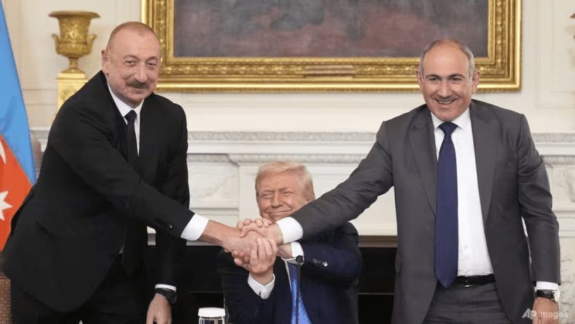 President Donald Trump, center, shakes hands with Armenian Prime Minister Nikol Pashinyan, right, and Azerbaijan President Ilham Aliyev during a trilateral signing ceremony in the State Dining Room of the White House, Friday, Aug. 8, 2025, in Washington. (Photo: AP/Mark Schiefelbein)
