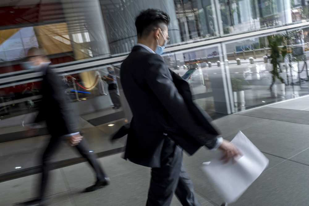 Commuters underneath the HSBC Holdings Plc headquarters building in the Central district of Hong Kong. (Bloomberg) Commuters underneath the HSBC Holdings Plc headquarters building in the Central district of Hong Kong. (Bloomberg)