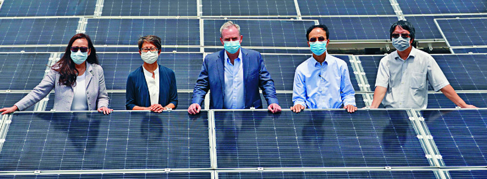 The university's existing solar panel setup is an apt backdrop for Maria Leung, far left, and David Bookhart. The university's existing solar panel setup is an apt backdrop for Maria Leung, far left, and David Bookhart.