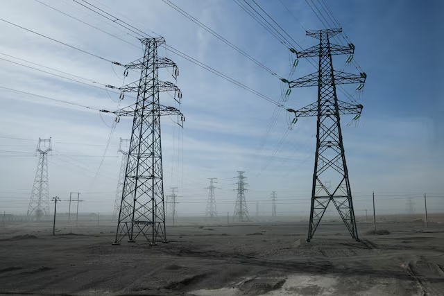 A general view of electricity pylons during an organised media tour in Jiuquan, Gansu province, China October 17, 2024. REUTERS/Tingshu Wang/File Photo 