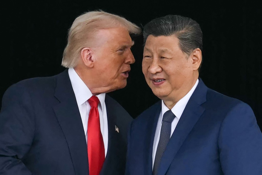 Photo by ANDREW CABALLERO-REYNOLDS / AFP  US President Donald Trump (L) talks to China's President Xi Jinping as they shake hands after their talks at the Gimhae Air Base, located next to the Gimhae International Airport in Busan on October 30, 2025.