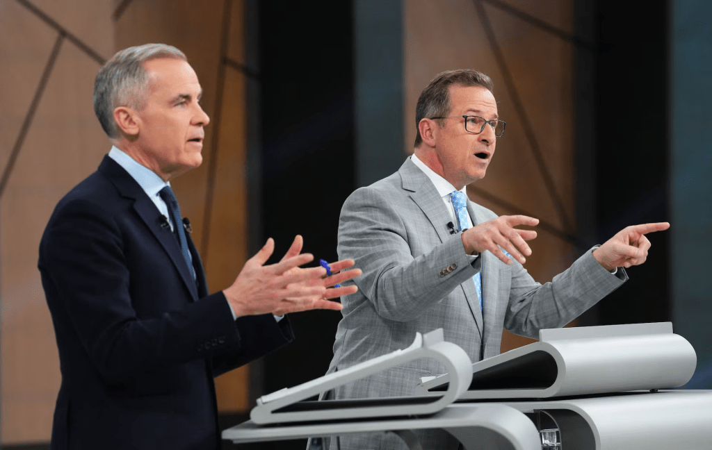Bloc Quebecois Leader Yves-Francois Blanchet and Canadian Prime Minister Mark Carney, the Liberal Party leader, both try to make points during the French-language federal leaders' debate, in Montreal, Quebec, Canada, April 16, 2025. Sean Kilpatrick/Pool via REUTERS