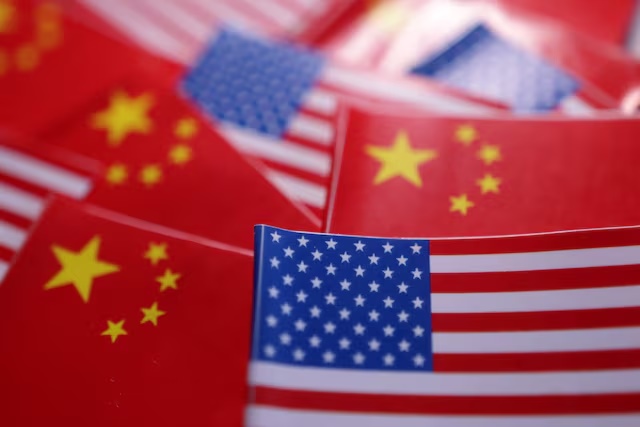 U.S. and Chinese flags are seen in this illustration taken March 20, 2025. REUTERS/Dado Ruvic/Illustration 