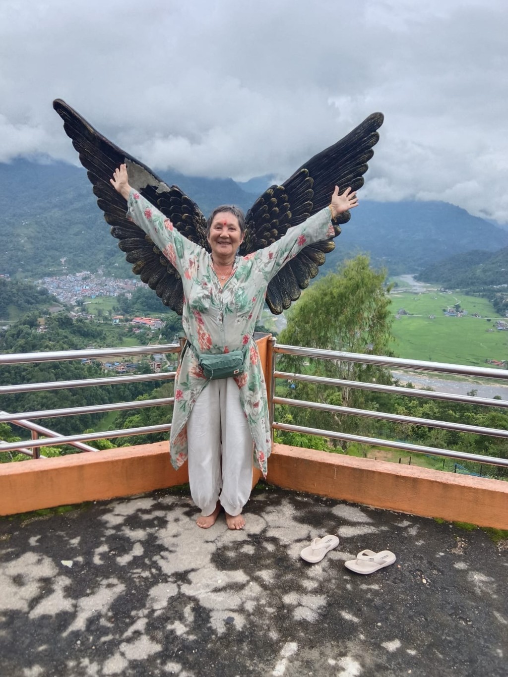 Photo by - / LUDMILA YILMAZ / AFP  This handout picture taken on July 30, 2026 shows Swiss pilgrim Natalia Rjumin-Girardet posing at Syangja View Tower in Putalibazar.
