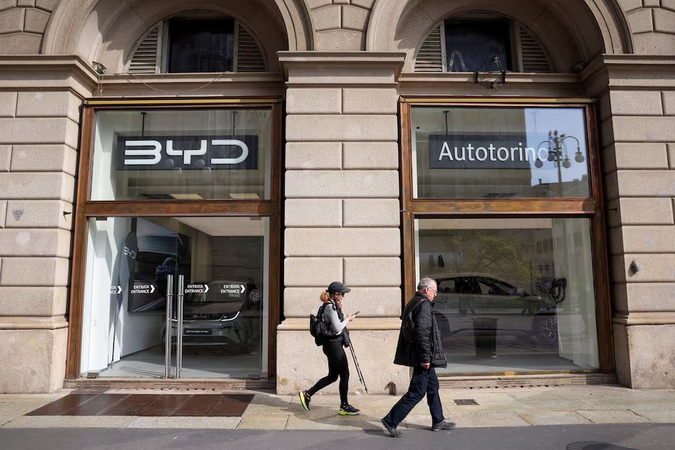 People walk in front of BYD Auto company and Autotorino store in Milan, Italy, March 20, 2024. (Reuters) People walk in front of BYD Auto company and Autotorino store in Milan, Italy, March 20, 2024. (Reuters)