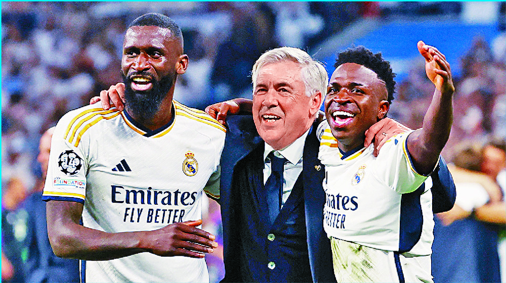 Carlo Ancelotti celebrates a 'magical' victory with Antonio Rudiger, left, and Vinicius Junior. REUTERS