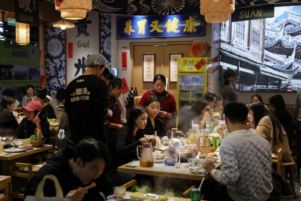 Customers dine at a restaurant in Beijing, China October 19, 2025. REUTERS