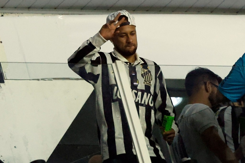 Neymar gestures from the stands as he attends a recent Copa Sudamericana match between Brazil's Santos and Ecuador's Deportivo Cuenca. AFP
