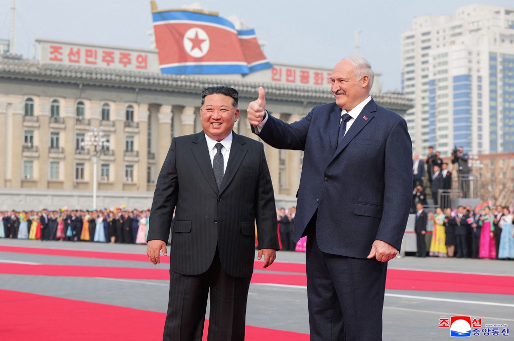 This picture taken on March 25, 2026 and released by North Korea's official Korean Central News Agency (KCNA) on March 26, 2026 shows North Korean leader Kim Jong Un (L) and Belarus' President Alexander Lukashenko (R) attending a welcome ceremony at Kim Il Sung Square in Pyongyang. (Photo by KCNA VIA KNS / AFP)