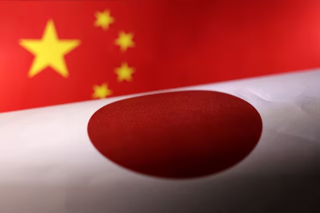 Printed Chinese and Japanese flags are seen in this illustration, July 21, 2022. REUTERS/Dado Ruvic/Illustration