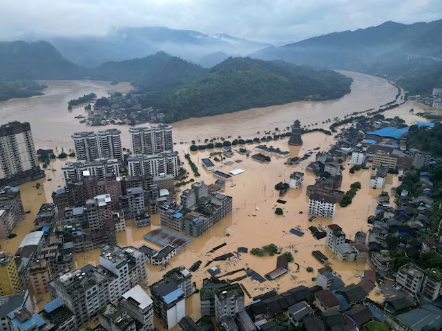 A drone view shows buildings and roads are half submerged in floodwaters after heavy rainfalls, in Rongjiang county, Guizhou province, China June 24, 2025. China Daily via REUTERS/File Photo