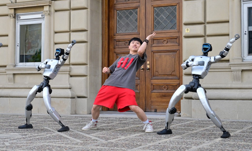 Photo by FREDERIC J. BROWN / AFP  Chinese street dancer Wu Yufei performs alongside Unitree Robotics humanoid robots during a demonstration in Pasadena, California, on September 17, 2026, ahead of their performance in the Season 21 finals of "America's Got Talent" on September 22.