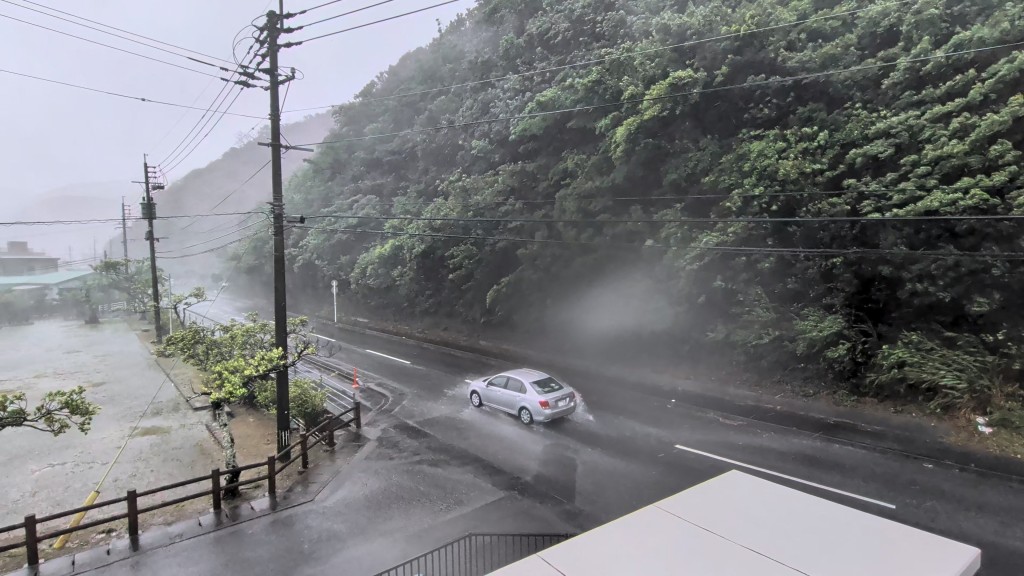A car makes its way through strong winds and rain as Typhoon Dolphin approaches, in Nazeasahicho, Amami, Kagoshima, Japan (Reuters)