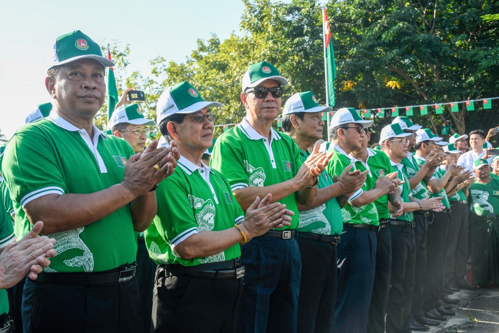 Photo by STR / AFP  Myanmar's retired General Tin Aung San (L) and candidate for the army-backed ruling Union Solidarity and Development Party (USDP) attends a campaign kick-off event in Naypyidaw on October 28, 2025.