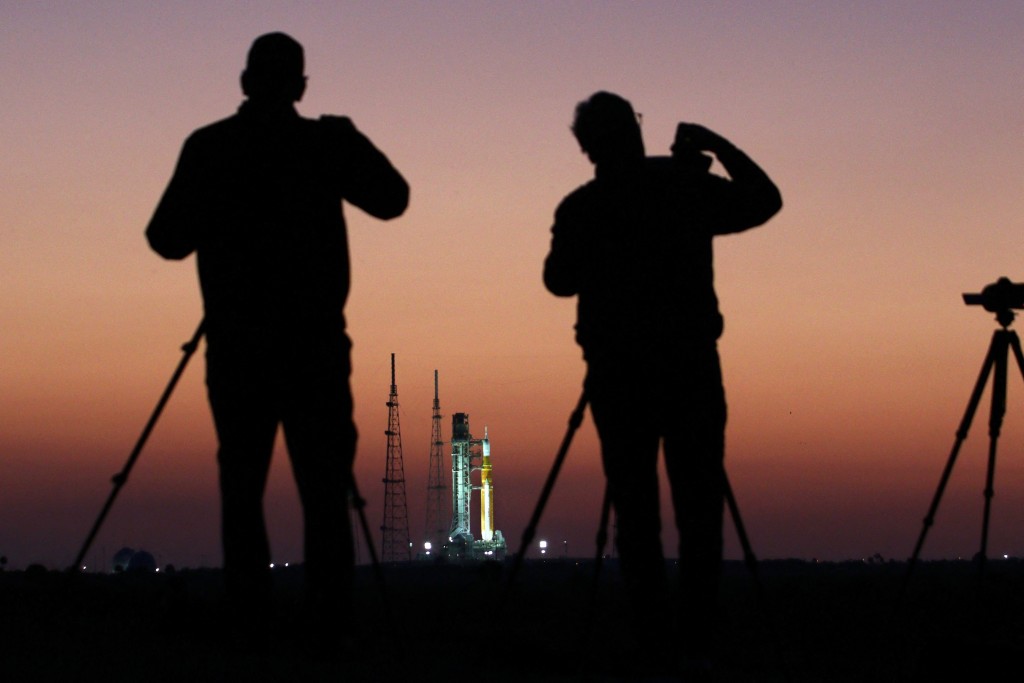 Photo by GREGG NEWTON / AFP  News media observe NASA's Artemis II Space Launch System (SLS) rocket and Orion spacecraft before sunrise at Launch Pad 39B at the Kennedy Space Center in Cape Canaveral, Florida on March 24, 2026.