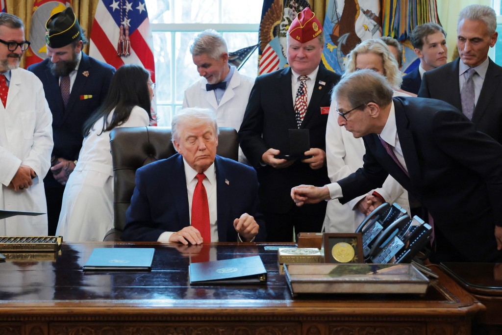 U.S. President Donald Trump speaks with Howard Kessler (R) after signing an executive order in the Oval Office of the White House on December 18, 2025 in Washington, DC. During the ceremony, Trump signed the order reclassifying marijuana as a schedule III drug. Anna Moneymaker/Getty Images/AFP