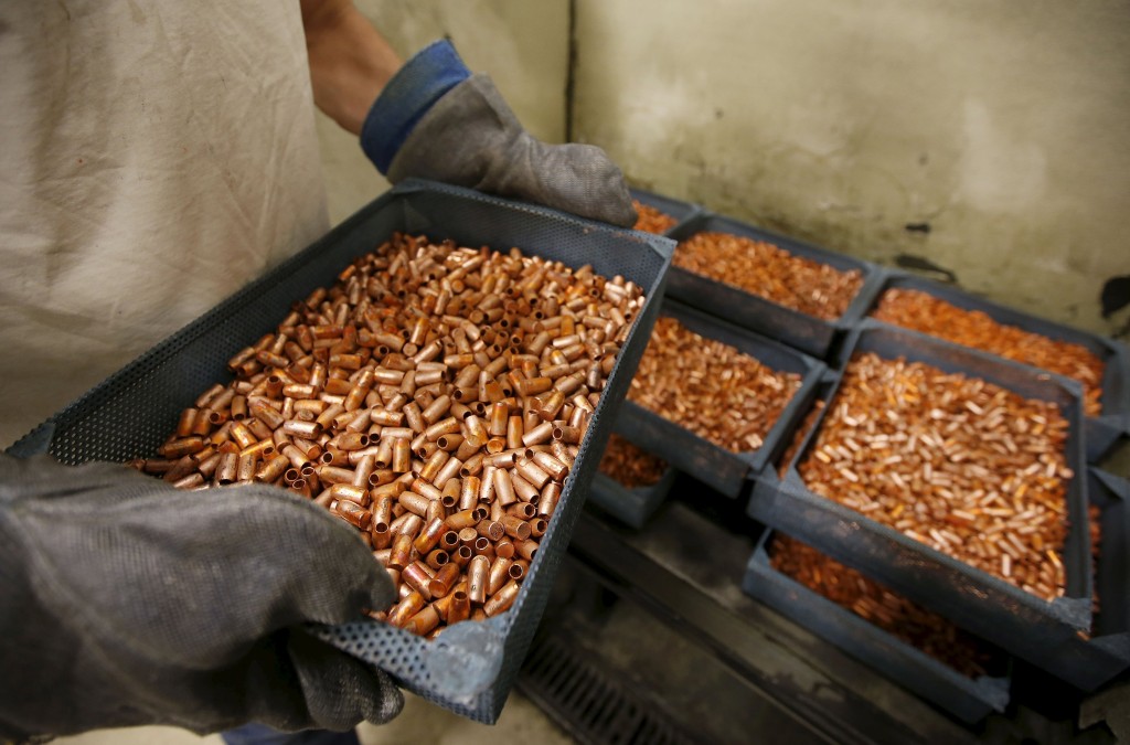 A worker transfers newly made copper slugs, to be pressed into bullets, at Barnes Bullets in Mona, Utah, in this January 6, 2016 file photo. Traders have been raising their bets on an even steeper decline in copper prices in the coming months, worried that Chinese demand is dwindling just as investment made when markets were booming unleashes a new wave of supply. REUTERS/George Frey/Files