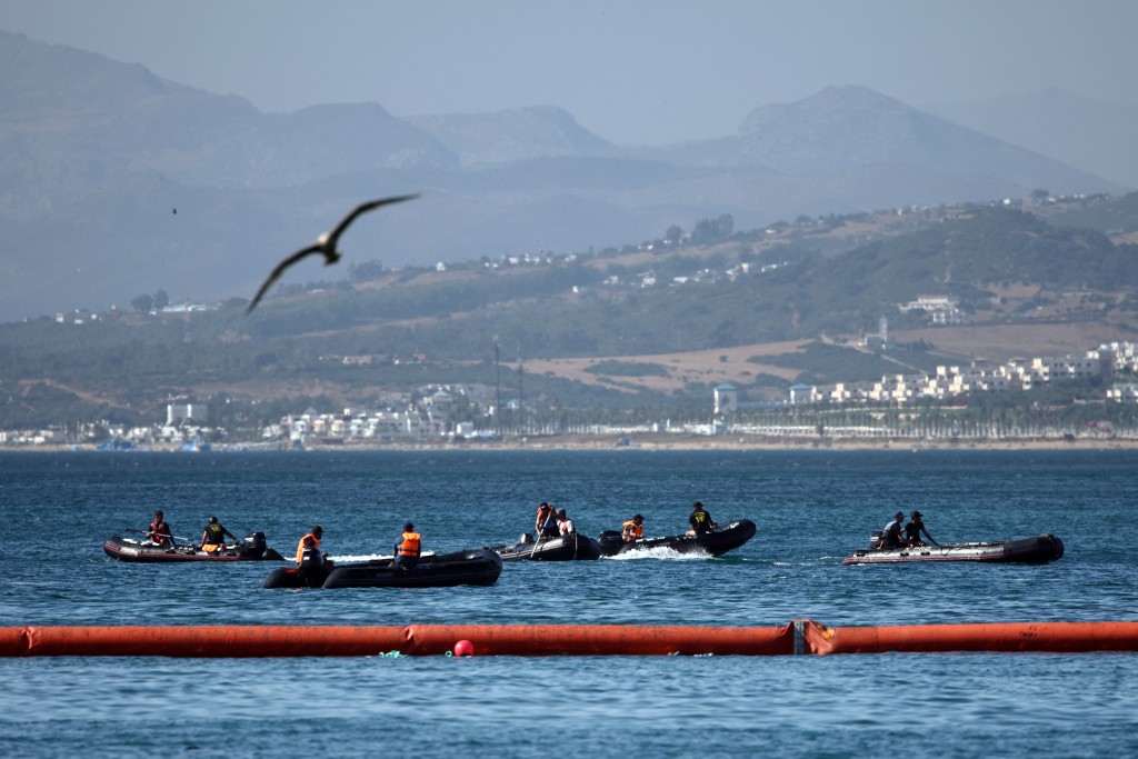 People aboard inflatable boats navigate on the Moroccan side of the new floating barrier deployed by Spain to reinforce security near the border post of the Spanish enclave of Ceuta on August 2, 2026. (AFP)