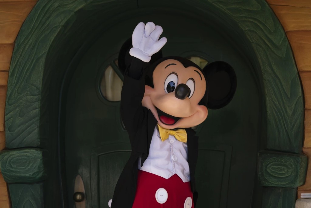 Mickey Mouse interacts with guests at Disneyland in Anaheim, Calif., Friday, April 30, 2021. (AP Photo/Jae C. Hong, File)