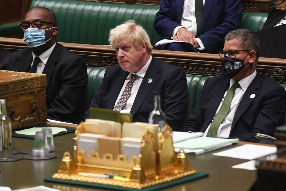 Prime Minister Boris Johnson (center) sitting between Britain's Business Secretary Kwasi Kwarteng (left) and Britain's President for COP26 Alok Sharma (right) in the House of Commons in London on November 15, 2021. Photo by AFP. Prime Minister Boris Johnson (center) sitting between Britain's Business Secretary Kwasi Kwarteng (left) and Britain's President for COP26 Alok Sharma (right) in the House of Commons in London on November 15, 2021. Photo by AFP.