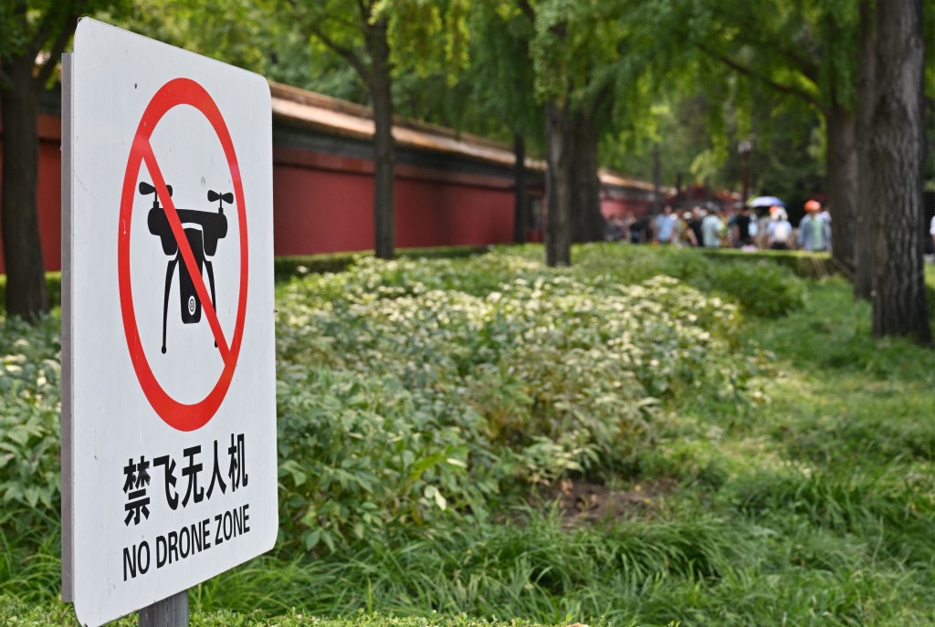 Photo by ADEK BERRY / AFP. This picture shows a "No Drone Zone" sign in Beijing on September 19, 2026.