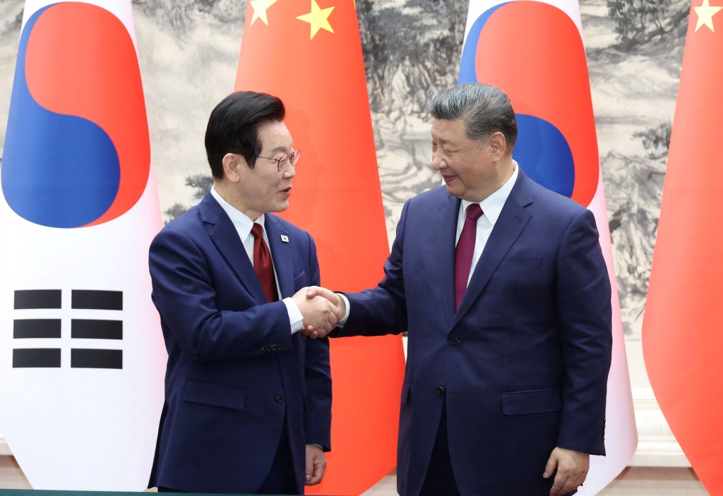 Chinese President Xi Jinping shakes hands with South Korean President Lee Jae Myung during a MOU Signing Ceremony at the Great Hall of the People in Beijing, China, January 5, 2026. (Reuters)