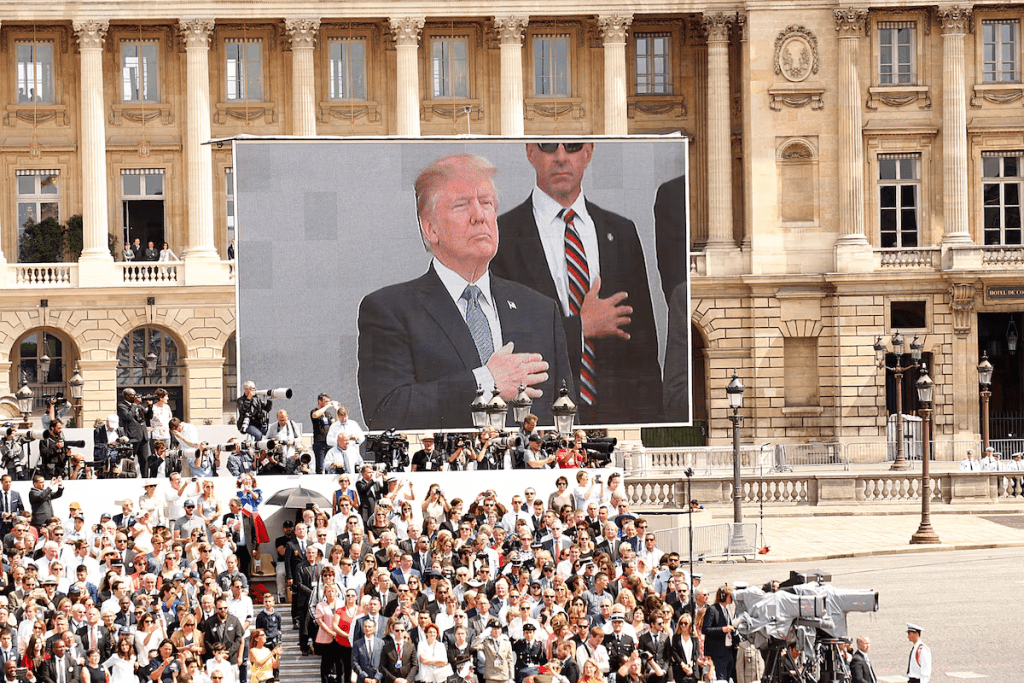 U.S. President Donald Trump is seen on a giant screen on the Place de la Concorde during the traditional Bastille Day military parade on the Champs-Elysees in Paris, France, July 14, 2017. REUTERS/Kevin Lamarque/File Photo