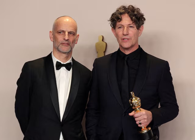 Director Jonathan Glazer poses alongside producer James Wilson with the Oscar for Best International Feature Film for "The Zone of Interest" of United Kingdom in the Oscars photo room at the 96th Academy Awards in Hollywood, Los Angeles, California, U.S., March 10, 2024. REUTERS/Carlos Barria/File Photo