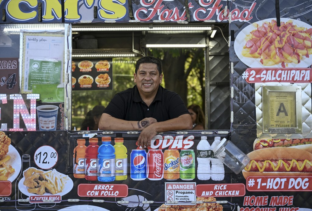 Photo by ANGELA WEISS / AFP Food vendor William Arevalo poses for a picture in his electric battery powered food cart in Flushing Meadows-Corona Park on July 23, 2026 in New York City.